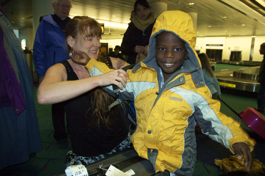 Echo helps Wisler put on his winter coat as they prepare to go home.