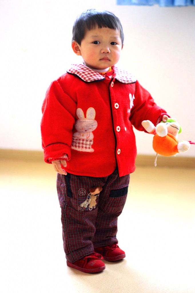 Toddler wearing a red jacket in China