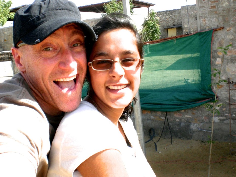 Amanda and her dad riding an elephant.