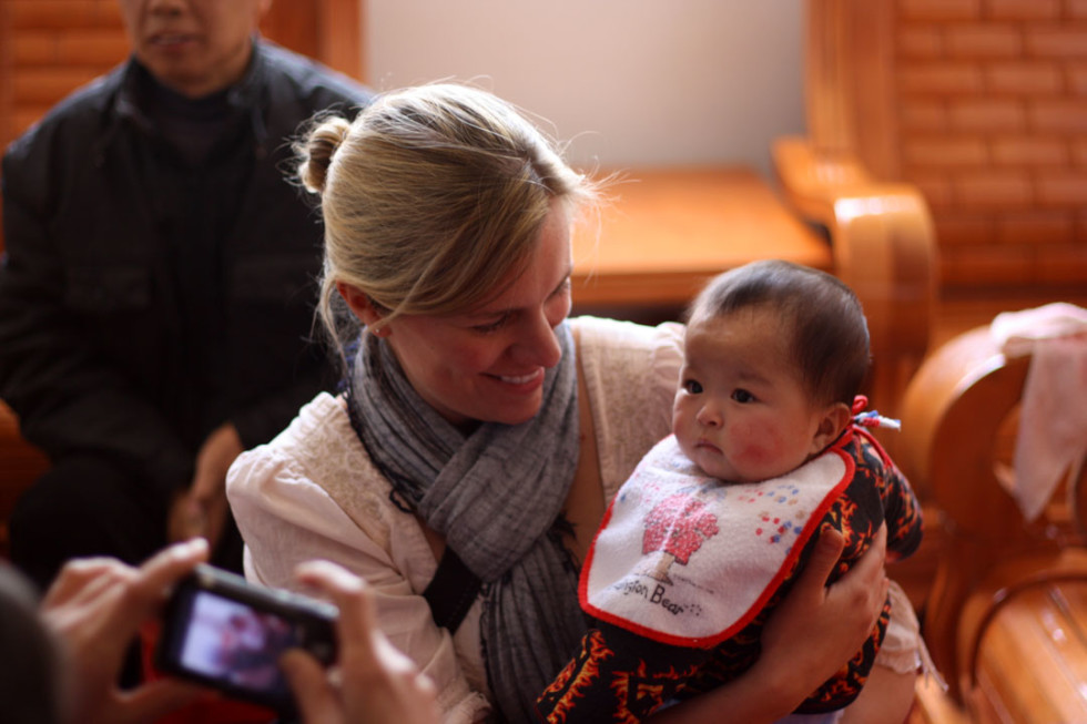 Ingrid holds a child in care at the Shangrao orphanage.