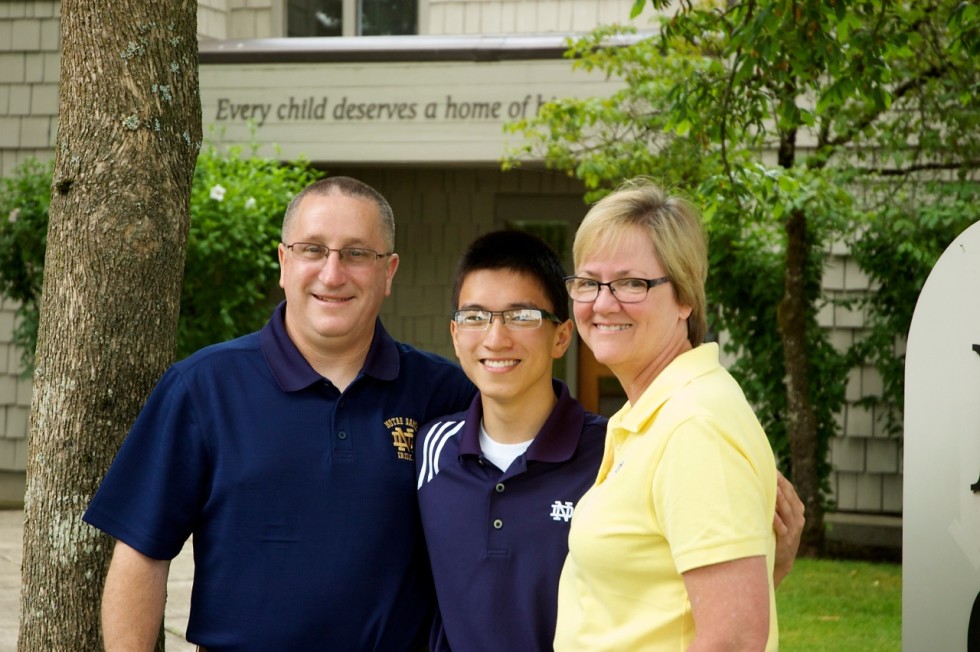 Kyle Witzigman with his parents, Todd and Cindy, outside the Holt International office in Eugene, Oregon.
