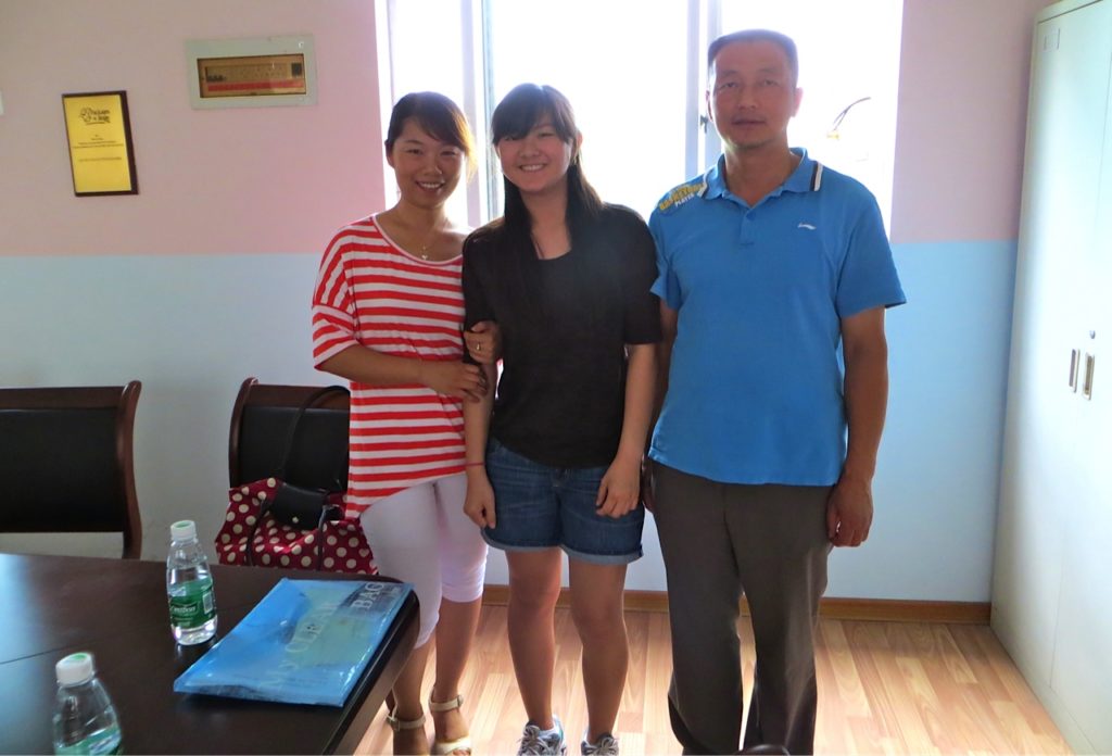 Grace with the orphanage director and assistant director, Ms. Pong, who handed her to her mother 14 years ago.