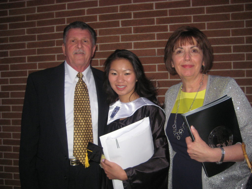 Liana with her parents on her graduation day.