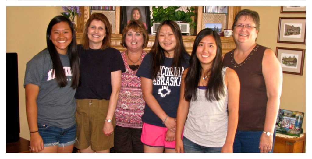 Seventeen years after they arrived in the U.S., the girls and their mothers reunite at Kathryn’s home in Minnesota. From left, Annie and Kay Detweiler, Sarah and Janelle Lutjens, and Kathryn Kaiser with her mom, Sheryl. 