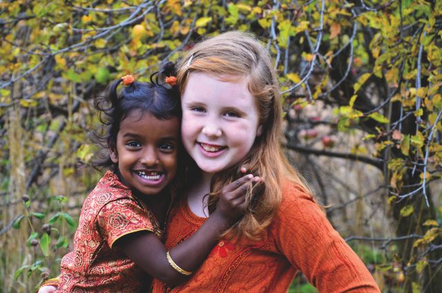 Indian adoptee and her adoptive sister smiling