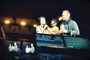 Standing beside NewSong’s Eddie Carswell, Kari and Asa share their story to help promote sponsorship at a recent Winter Jam concert. 