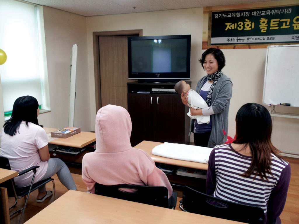 A member of the shelter’s staff teaches a parenting course to women who plan to parent their child.