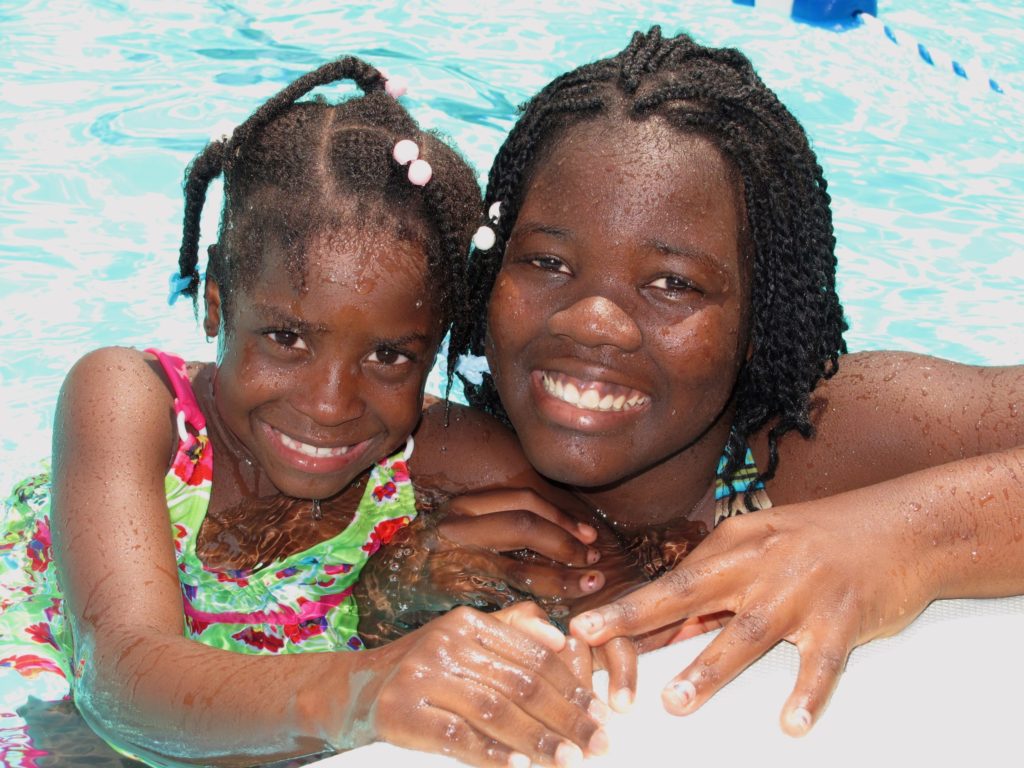 An adoptive family spending time at the pool during adoptee camp.