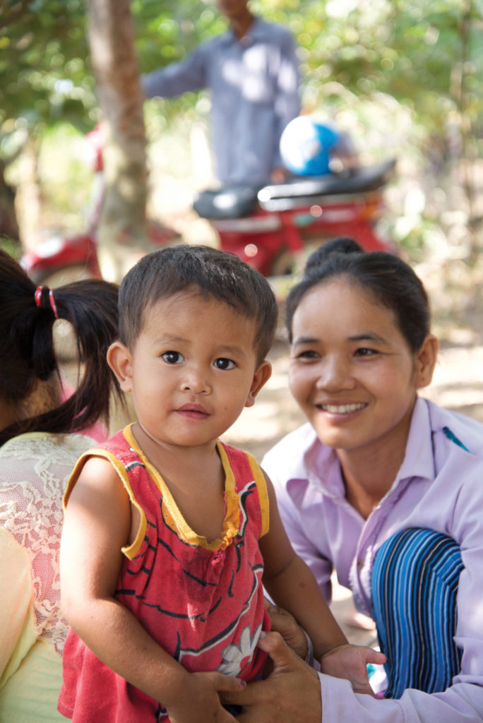 A mother and daughter pose for a photo.