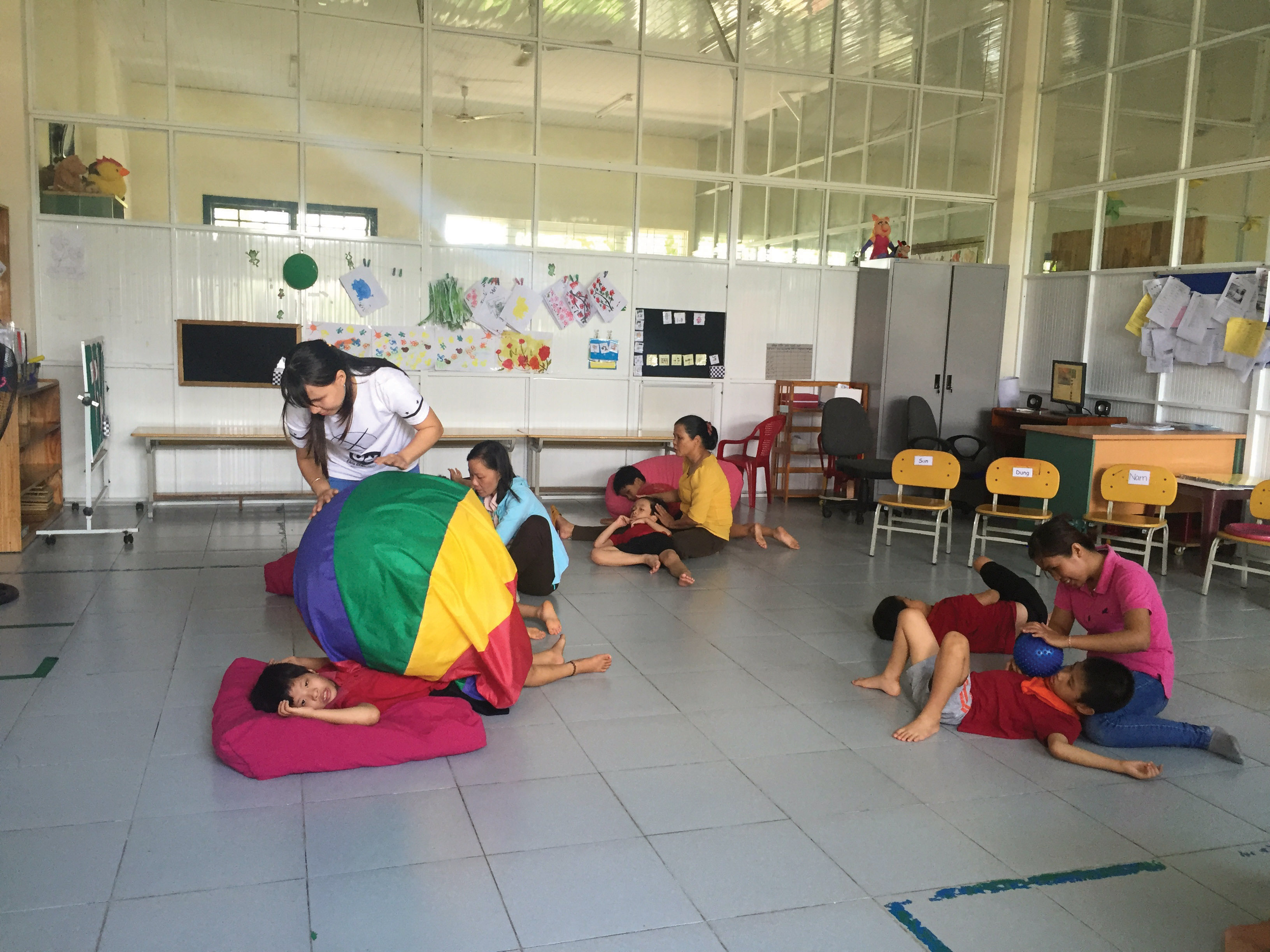 Children receiving one-on-one sensory therapy.