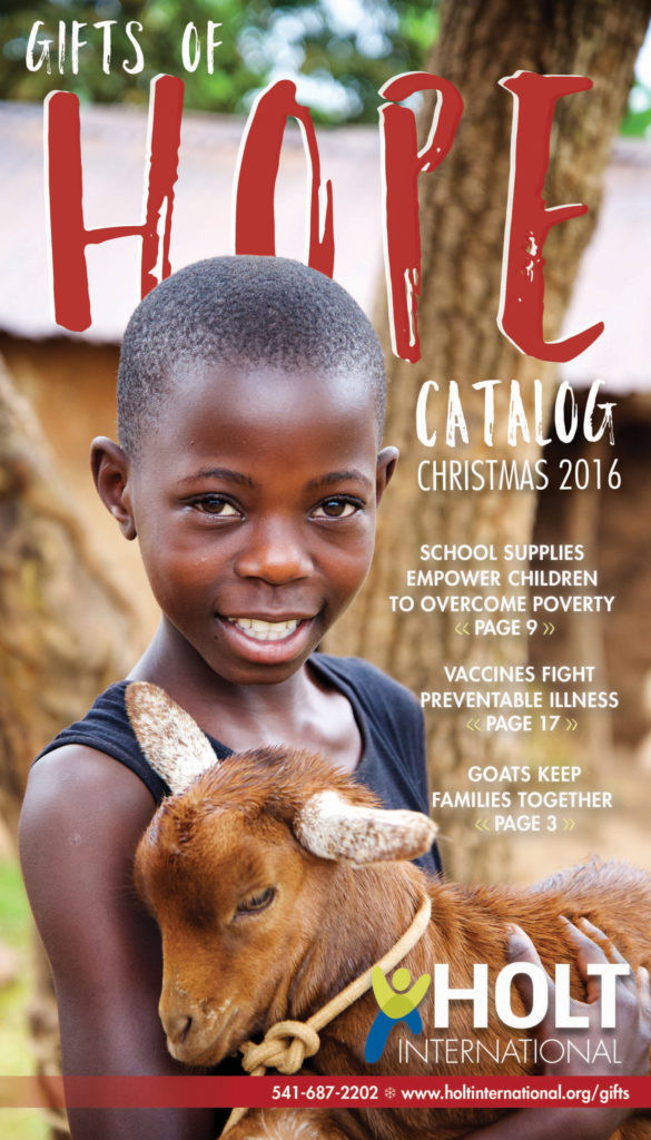Sponsored child in Uganda holding a goat on the cover of the Holt Gifts of Hope catalog.