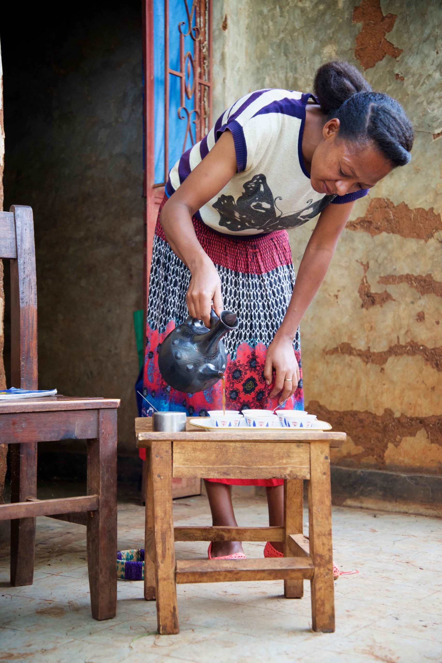 Woman pouring coffee in Ethiopia