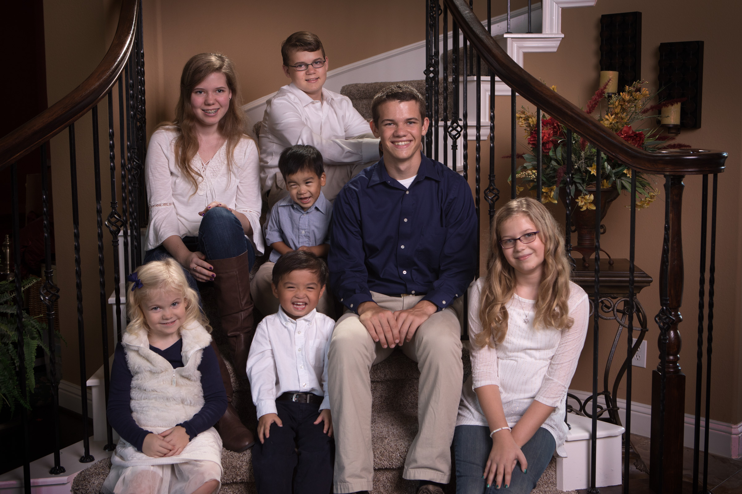 Levi, adopted from China, sits surrounded by his six brothers and sisters.