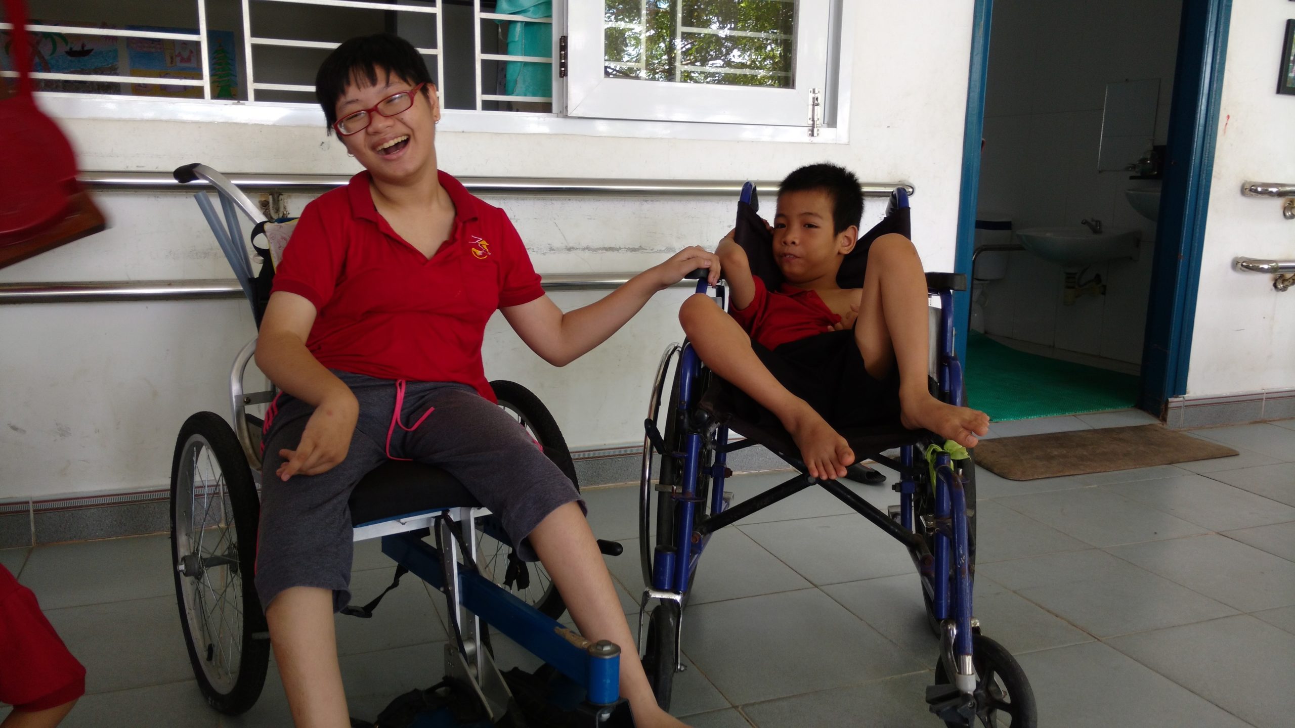 Two boys sitting in wheelchairs at the Kianh Foundation