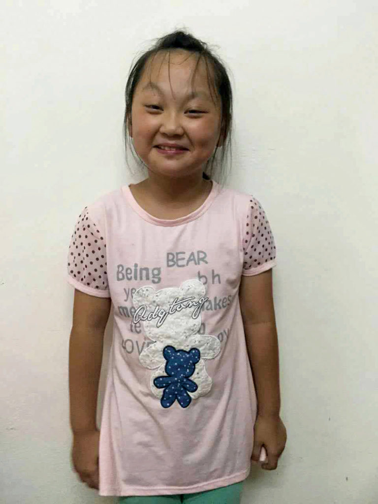 Photo of sponsored child Hui smiling