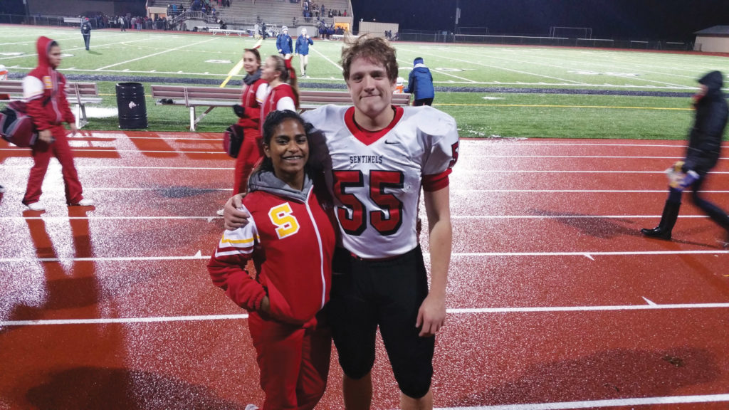 At their school’s last football game of the season, Malini cheered especially hard for her brother, Connor, both of them pictured here.