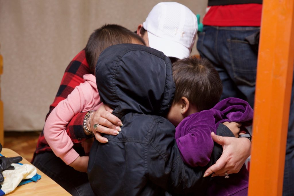Kim huddles together with the kids for a group hug.