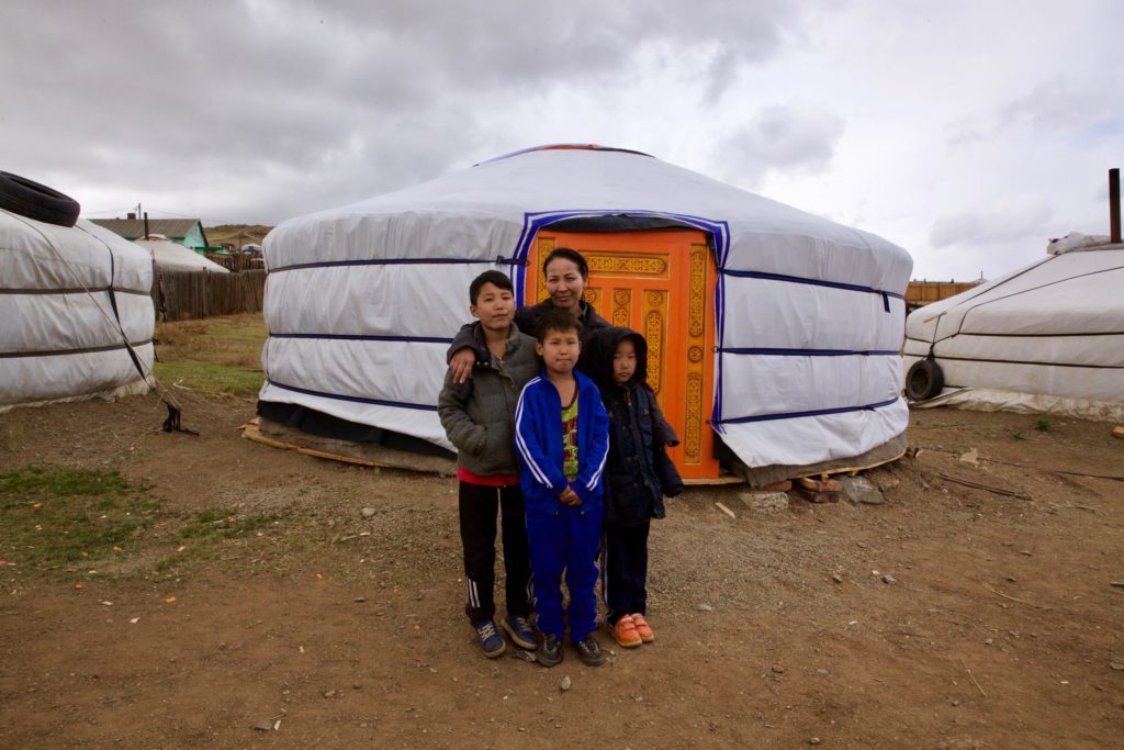 Amin-Erdene with her mom and two of her big brothers in front of their new ger.