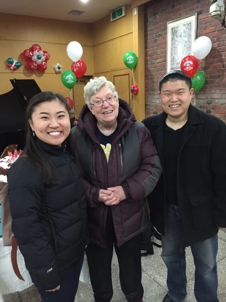 three people standing and smiling