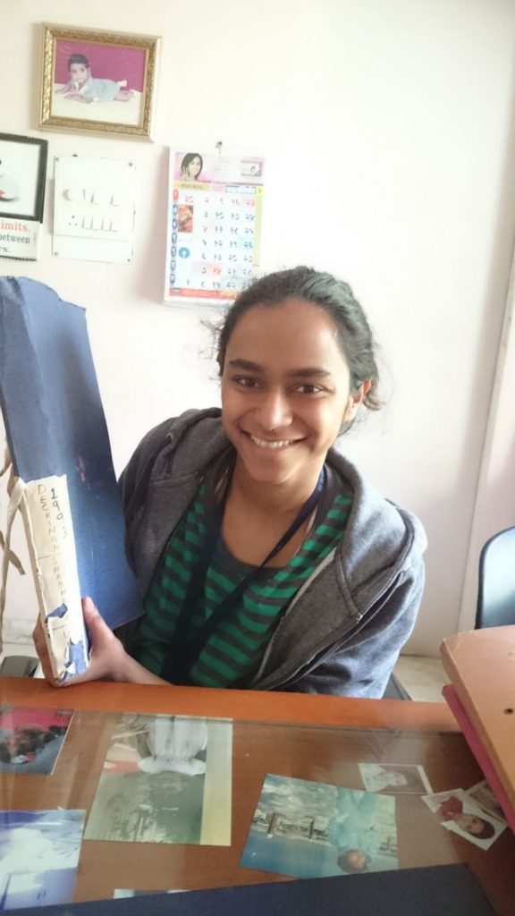 Shabana holding up her adoption file