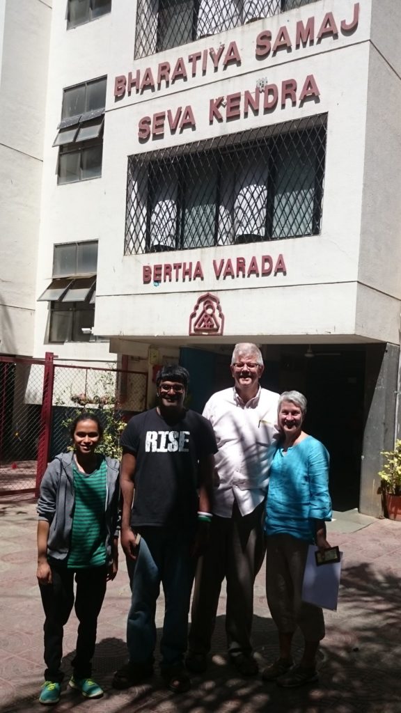 Shabana with her family in front of BSSK, the orphanage in India she was adopted from