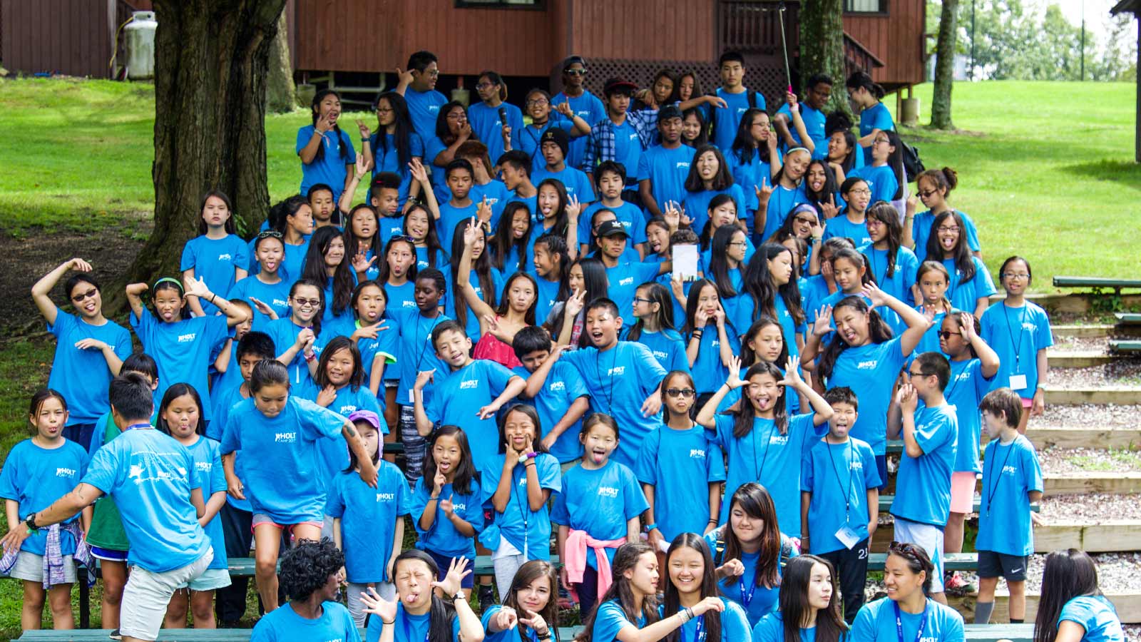 group of adoptees at Holt Camp wearing blue shirts
