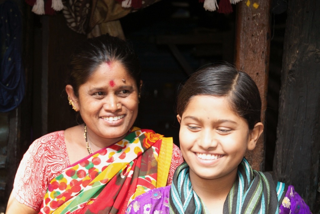 Raji with her mother outside their home.