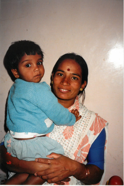 Phillip in the arms of a caregiver at his care center in Pune, India.