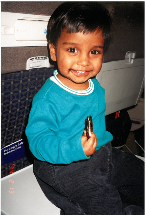 Phillip eating an Oreo cooking on the plane. Char gave it to him.