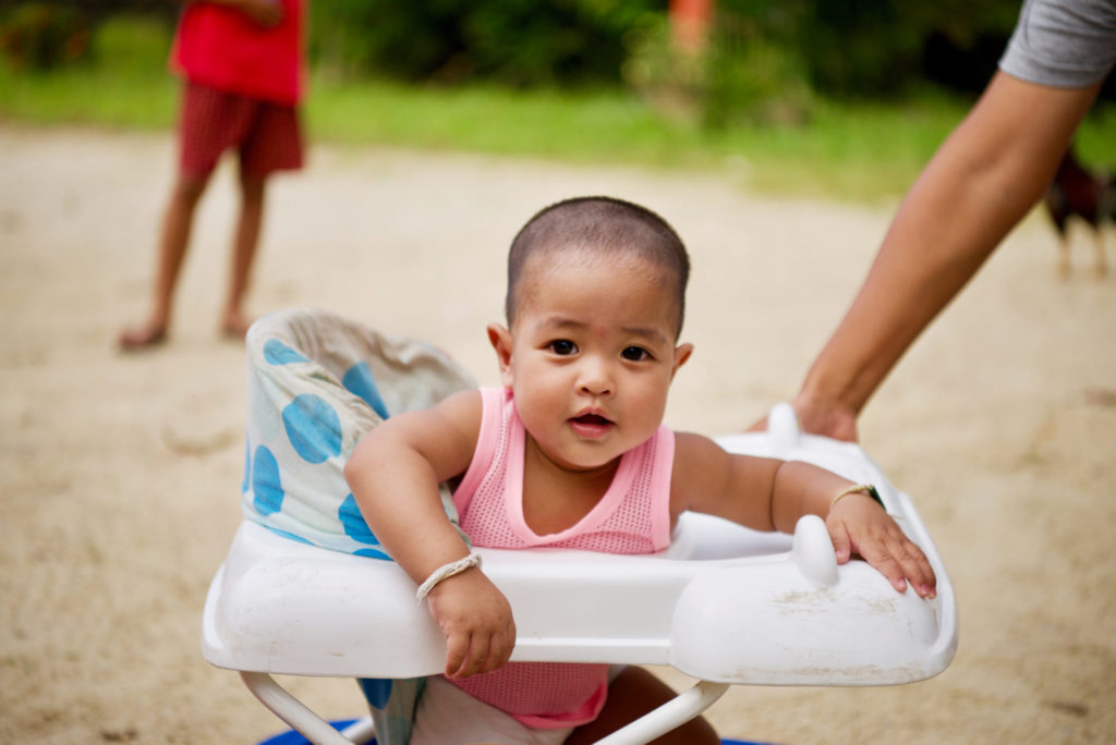 One of Ping's twins in a walker.