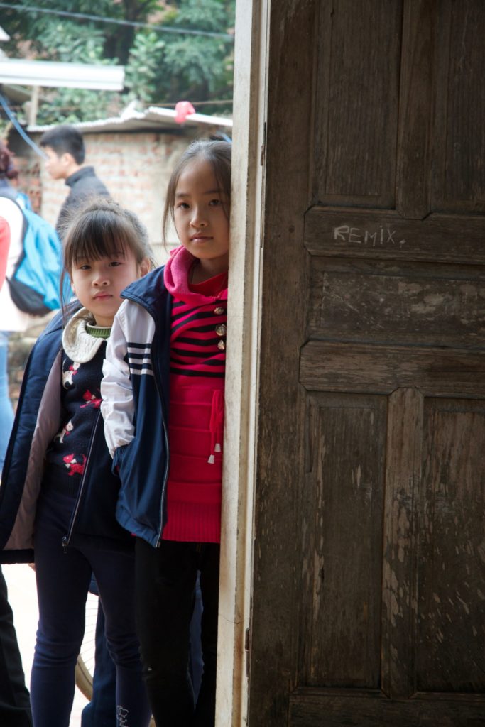 Two of Tieu's daughters standing in a doorway