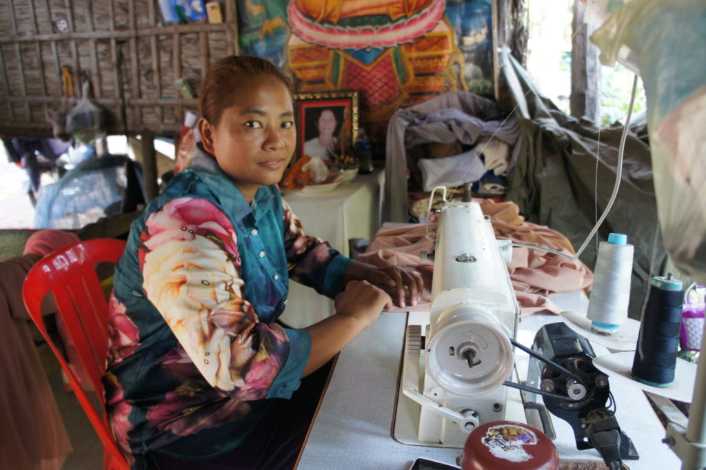 Sao sewing on her new gifted sewing machine through the Gifts of Hope program from donors through Holt International