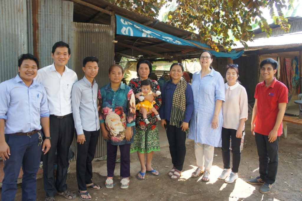 Sao (fourth from left) surrounded by Holt staff and social workers. Thoa stands second from right.