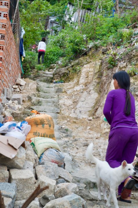 Linh and her mom climb the steps to their home. 