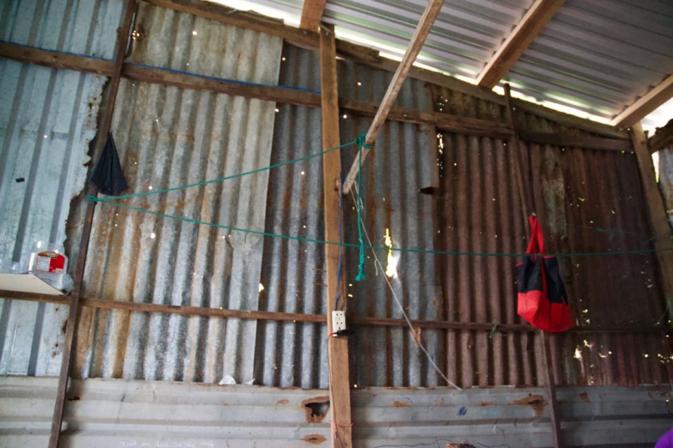 Although they now have a new tin roof, large open spaces between the roof and the walls let in rain and bugs, and light shines through holes in the wall like a constellation of stars.