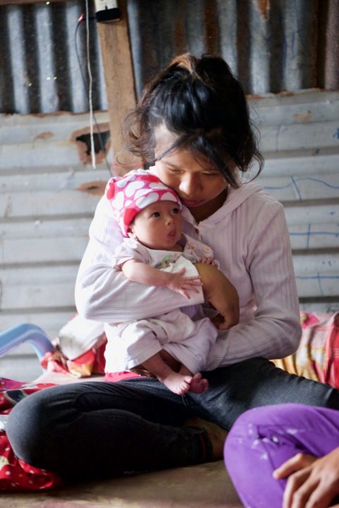 Linh holds her baby. 