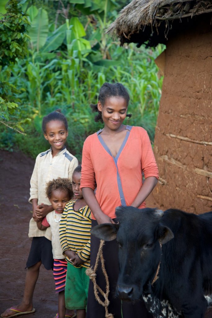 Meselech with her children and the cow she received as a Gift of Hope.