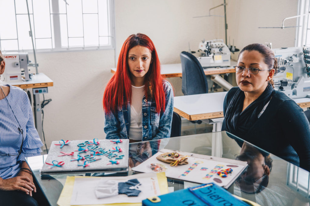 Erika meeting with counselors at BAMBI in one of the vocational training rooms where students learn sewing.