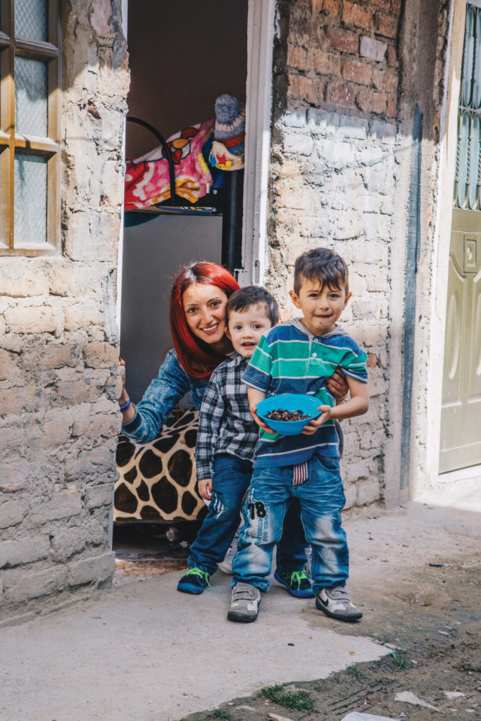 Erika and her sons, 3-year-old Teylor and 5-year-old Danny, outside the door to their one-room home.