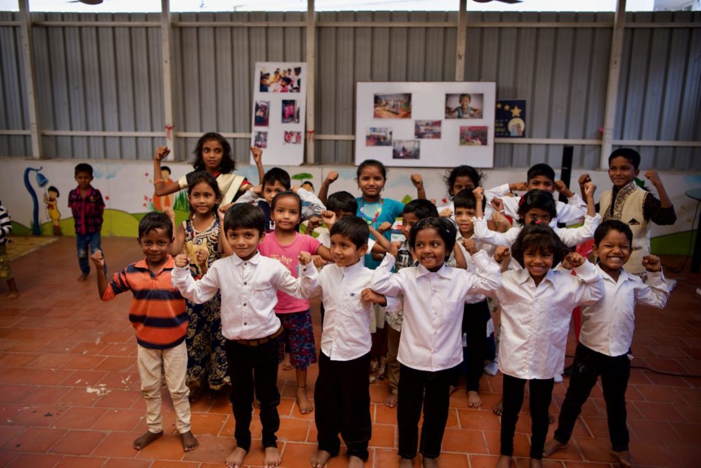 In the covered, yet open-air top floor of the VCT building, a group of older children perform a drama.