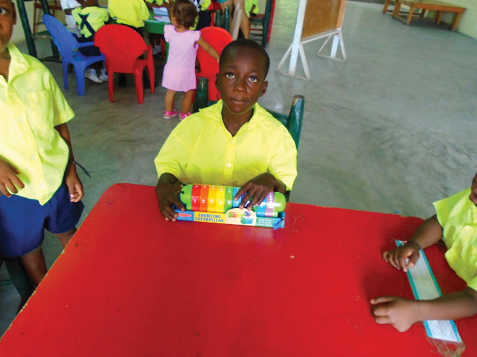 Fritz, 10, begins playing and learning with Fontana Village School's supplies.