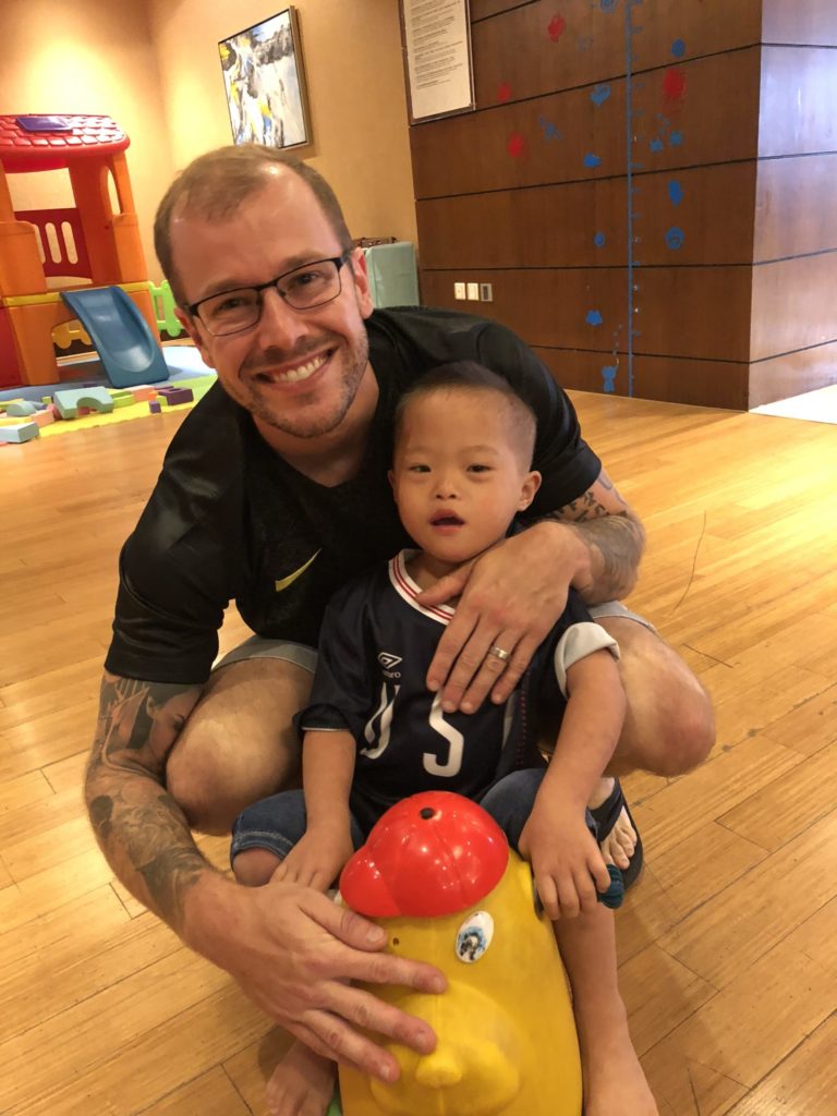 Micah with his dad in their first few weeks together in China. 