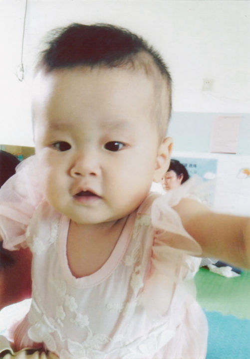 Shelby at her orphanage in China before coming home to her family.