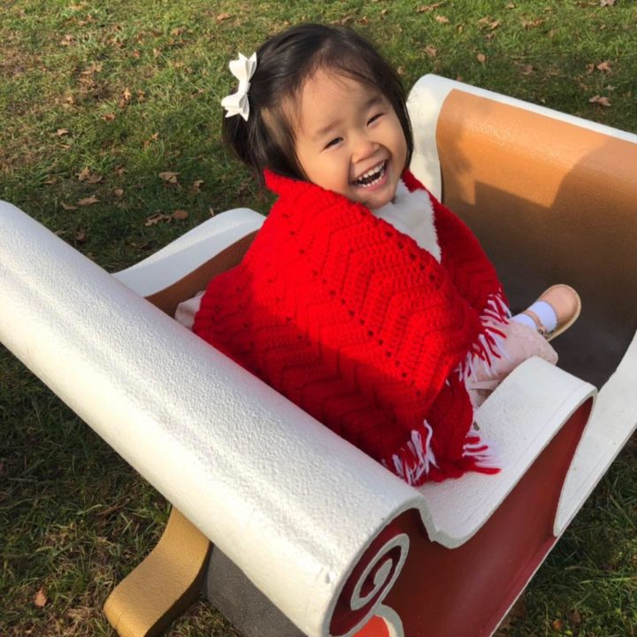 Shelby Jane posing in a sleigh.