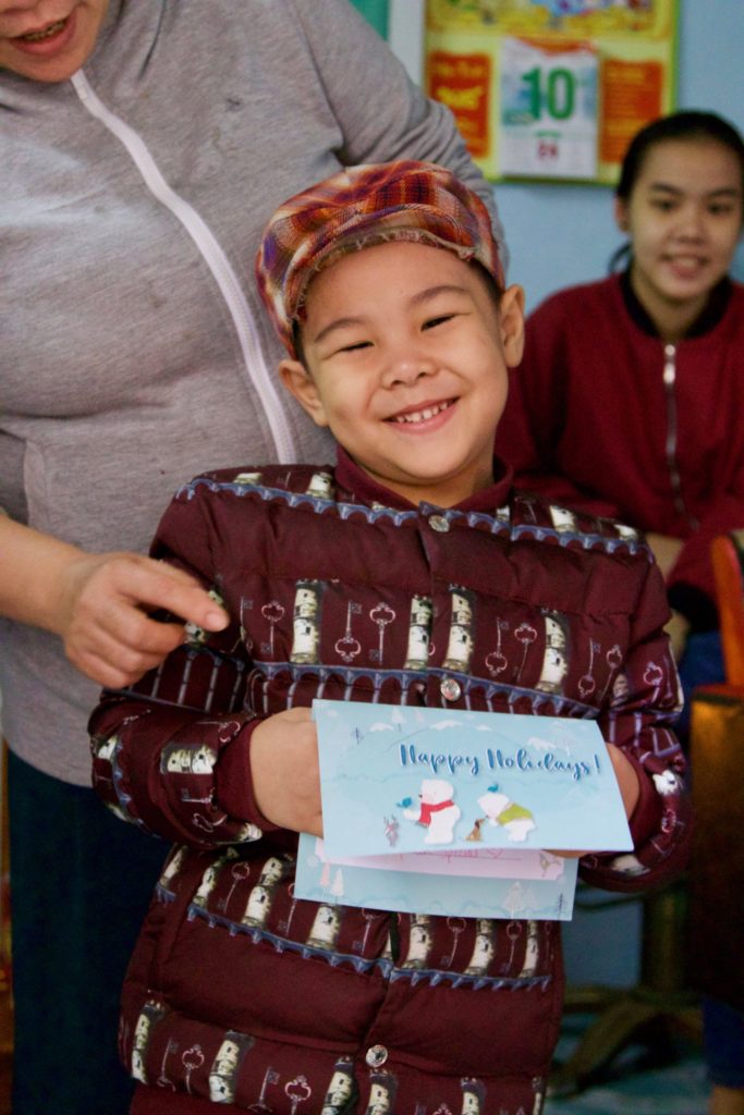 Hung holds a holiday card from his sponsor in the U.S.!