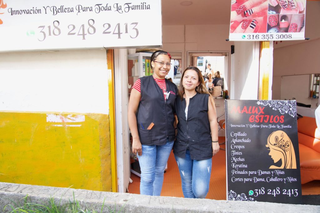 Outside of her salon Mary Luz stands beside Lorena, a fellow PROMEFA graduate who Mary Luz now employs as a manicurist in her salon.
