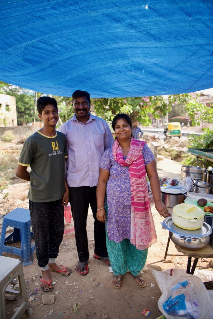 Sheela, her husband and her son at their food stand.