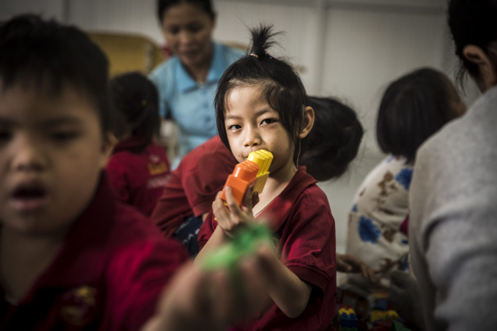 Vuong sits among her classmates at the Kianh Foundation Center.