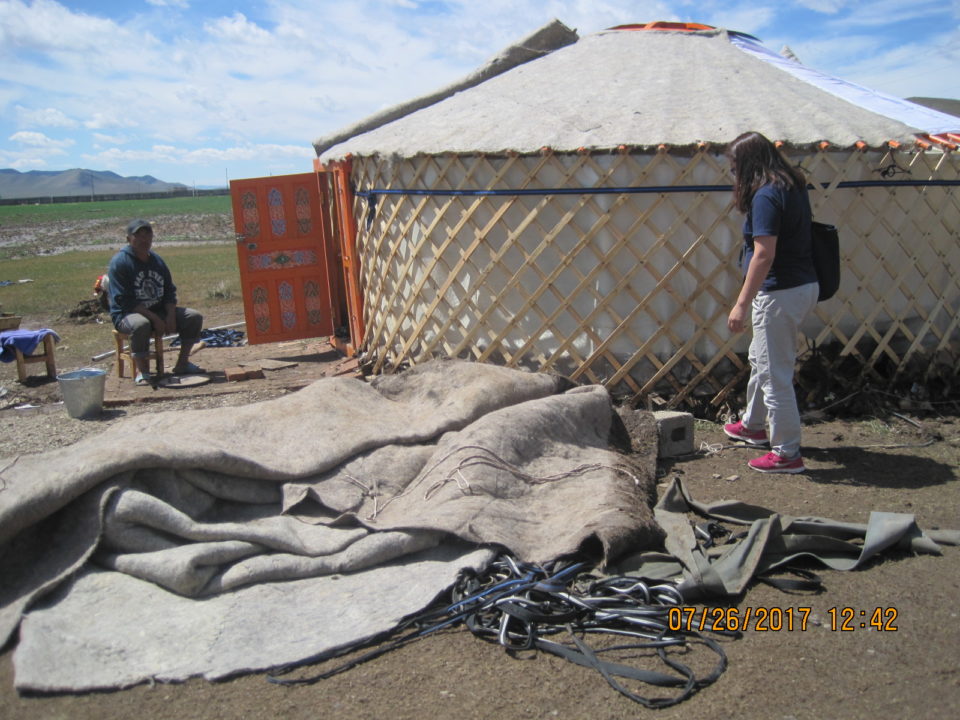 Lhagvajav sits outside his destroyed ger, in despair. 