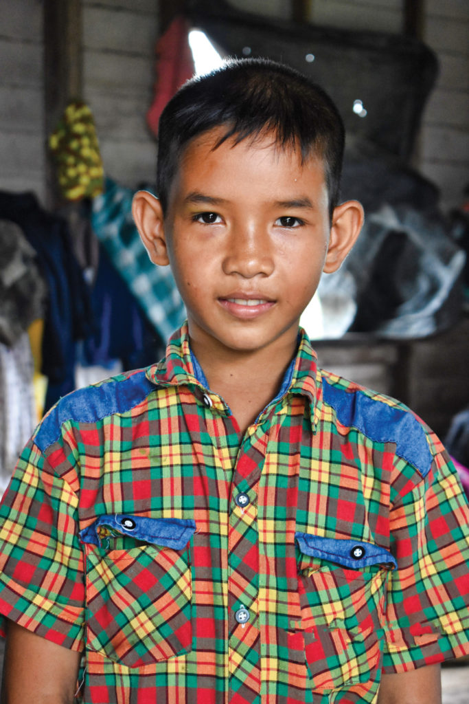photo of sponsored male child dressed in colorful plaid shirt